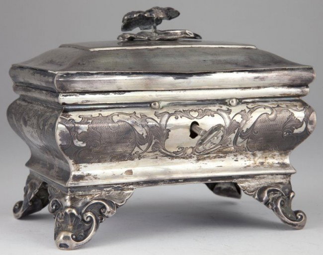 Silver Sugar Box, German, mid-19th century,: Silver Sugar Box, German, mid-19th century, with Berlin city hallmark and unidentified maker's mark, rectangular casket form raised on four applied scroll motif feet, the body with elaborate engraved 