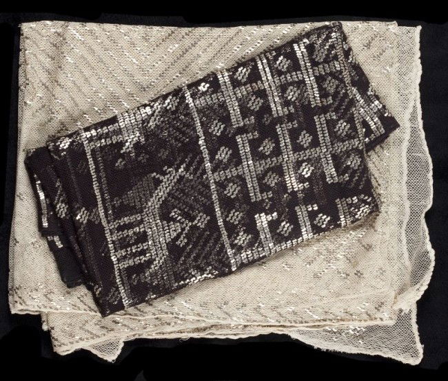 Three Egyptian Assuit Shawls: Three Egyptian Assuit Shawls circa 1920, each with hand applied sterling silver decoration on cotton net. The first being made of black cotton net features repeating patterns of girls in dress, men on