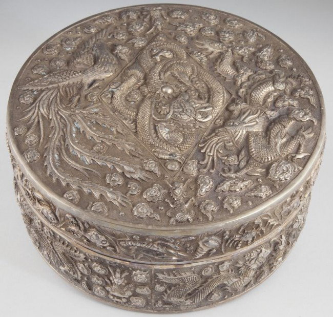 Cambodian Silver Repousse Betel Box: Cambodian Silver Repousse Betel Box 20th century, unusual round form, the lid decorated with Chinese-style dragons, a bird and various forms of sea life, the box sides feature lion-headed dragons. 4 h
