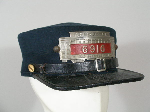 VintageNew York Railroad Conductor Hat,: New York Railroad Conductor Pill/Visor Hat, c. 1880s, blue wool w/black leather visor, metal badge shaped like a railroad car "Conductor 6916 Third Avenue System;" missing sweatband; this item is no l
