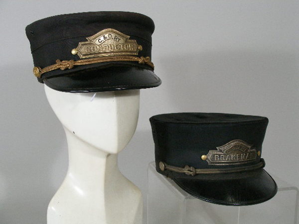 Two Vintage Chesapeake and Ohio Hats,: Two Chesapeake and Ohio Hats, c. 1940, black silk w/leather visor, metal badges "C.&O. RY Conductor" and "C&O RY Brakeman," wear and fading to silk, conductor hat w/scrape to visor; the first OL 8" x
