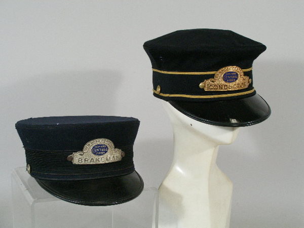 Two Vintage New York Central Railroad Hats,: Two New York Central Railroad Hats, the first a brakeman visor hat, navy w/leather visor, c. 1940 (some wear); and the second a 1950s black wool conductor hat, both w/metal badges, size 7 1/4; all ite