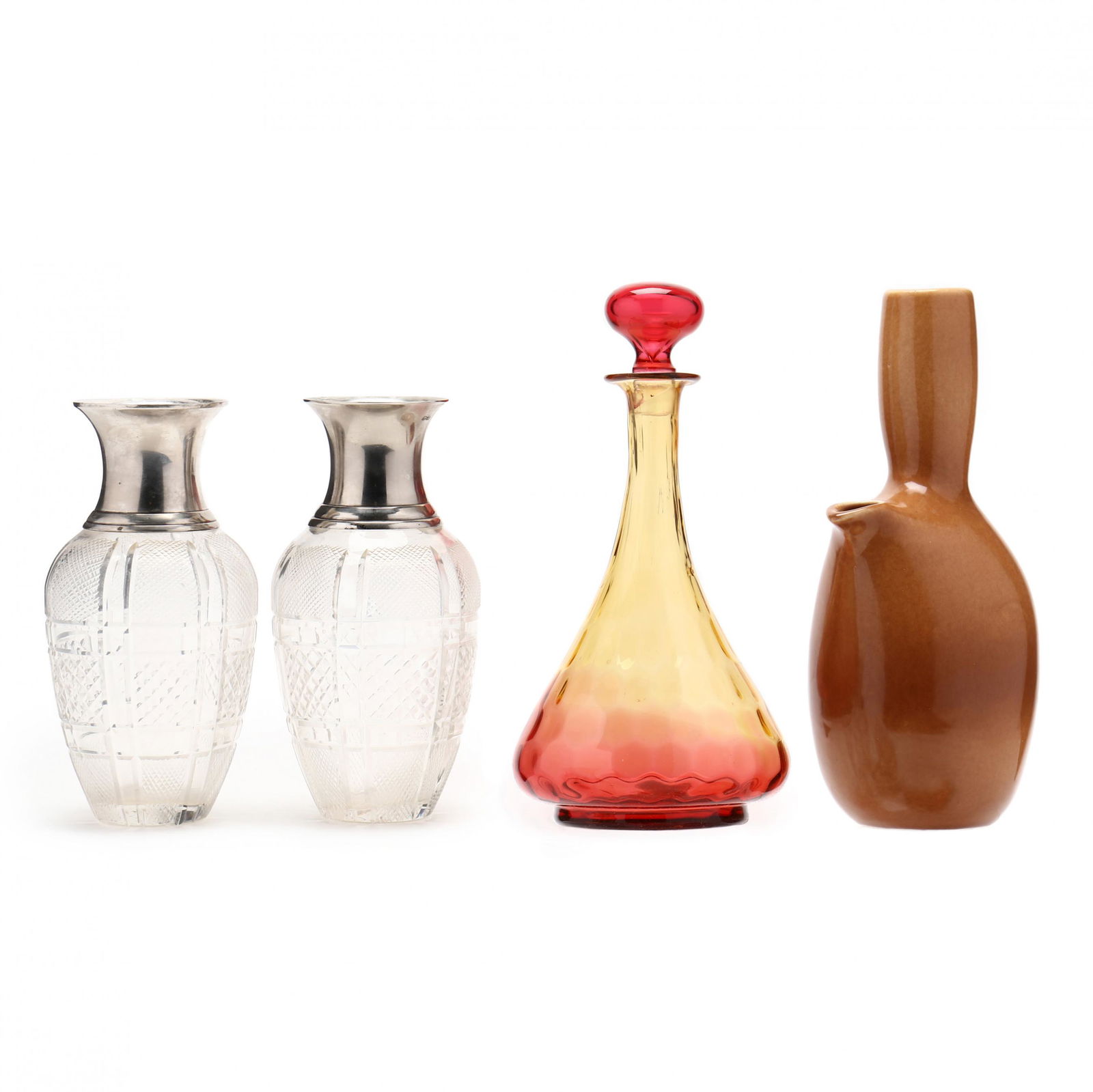 A Group of Table Accessories: A Group of Table Accessoriesa pitcher in the Iroquois pattern by Russel Wright (10 1/4 x 4 1/2 x 4 in.); a ruby glass decanter with stopper (10 x 5 in.) (large stopper chip); two baluster cut glass ca