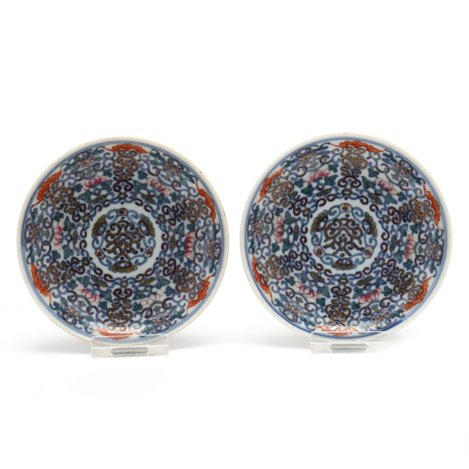 A Pair of Chinese Doucai Porcelain Saucers: A Pair of Chinese Doucai Porcelain Saucers 19th century, porcelain painted with ruyi, floral vines, iron red bats, fruit, and floral blooms with some gilt highlights, iron red lingzhi to exterior side