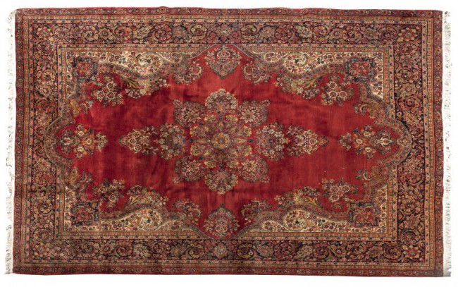 Persian Sarouk Carpet: Persian Sarouk Carpet circa 1940s, likely from Iran, hand-tied, red field with central medallion, strong color and pile, wool. 11 ft. 8in. x 8 ft. 7in.