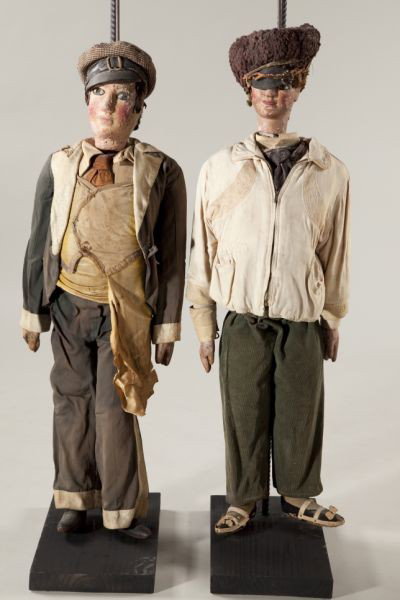 Two Antique Italian or Sicilian Rod Puppets: Two Antique Italian or Sicilian Rod Puppets late 19th century, carved polychrome heads, hands and feet, fabric costumes, a pair of capped young men are depicted, the first (39.5 in.) wearing a zippere