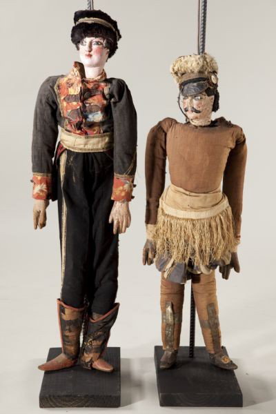 Two Antique Italian or Sicilian Rod Puppets: Two Antique Italian or Sicilian Rod Puppets late 19th century, carved polychrome heads, hands and feet, depicting soldiers, the first (37.5 in.) wears a cap, brown tunic, silk skirt and pantaloons, a 