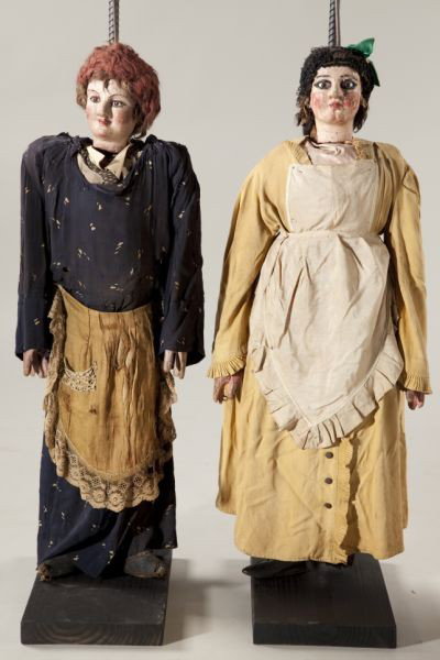 Two Antique Italian or Sicilian Rod Puppets: Two Antique Italian or Sicilian Rod Puppets late 19th century, carved polychrome heads, hands and feet, depicting women, both with glass eyes and silk aprons, the first (36.5 in.) a brunette wearing a