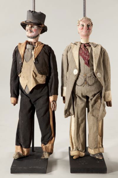 Two Italian or Sicilian Rod Puppets: Two Italian or Sicilian Rod Puppets late 19th century, carved polychrome heads, hands and feet, depicting gentlemen, the first (37.5 in.) wears a frock coat and chained waistcoat; the second (39 in.)