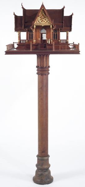 Large Southeast Asian Spirit House: Large Southeast Asian Spirit House wood construction with gilt highlights and window glass, the whole rests on a platform mounted to a carved post set into an iron base. 65.5 in. These elaborate model
