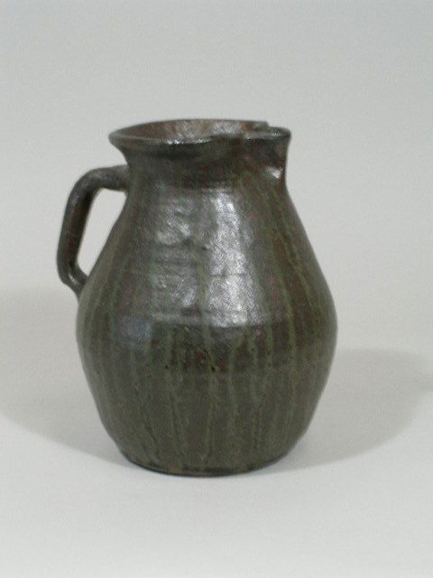 GA Folk Pottery Pitcher, Lanier Meaders,: GA Folk Pottery Pitcher, Lanier Meaders, wonderful dark green alkaline glaze w/somewhat lighter green runs, inscribed on the bottom "Lanier Meaders;" 9"h Est. 600-800