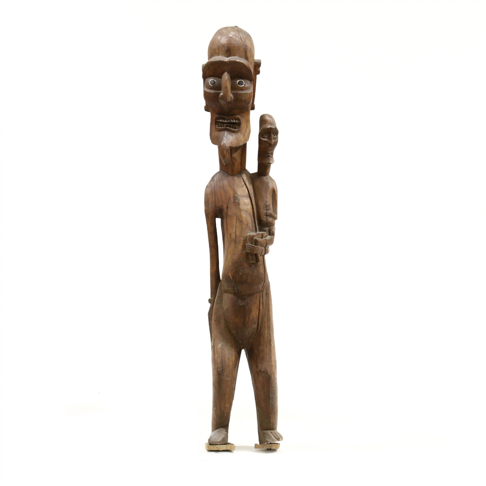 Large Standing Easter Island Figural Statue: Large Standing Easter Island Figural Statue20th century, Rapa Nui, Chile, carved from single piece of wood, inset fish bone and obsidian eyes beneath a powerful brow, pendulous ears, the larger figure