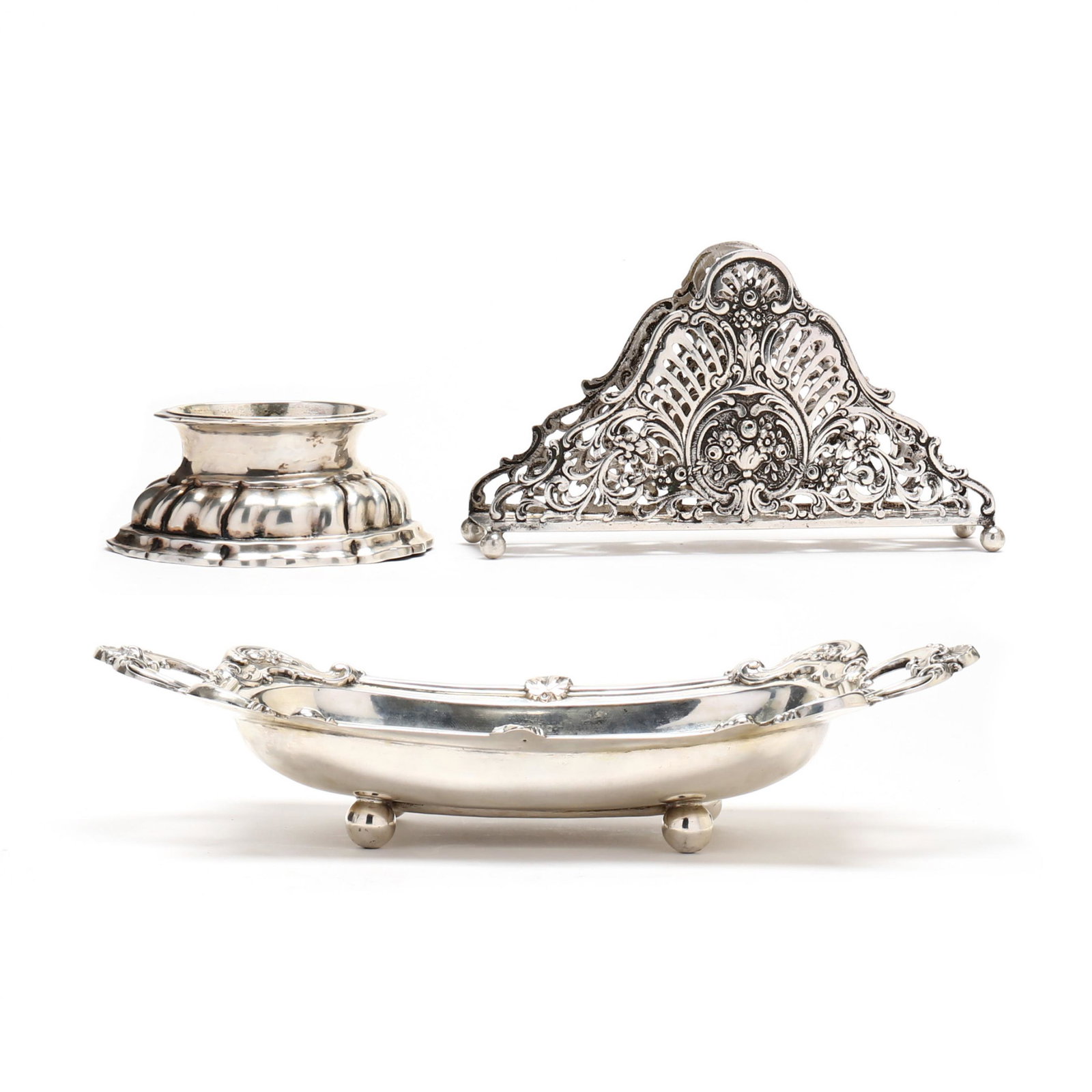 Three Continental Silver Table Accessories: Three Continental Silver Table Accessoriesthe first a German .800 silver napkin stand, post 1886 hallmarks, triangular form with reticulated floral and scrolling foliate sides, raised on four ball fee