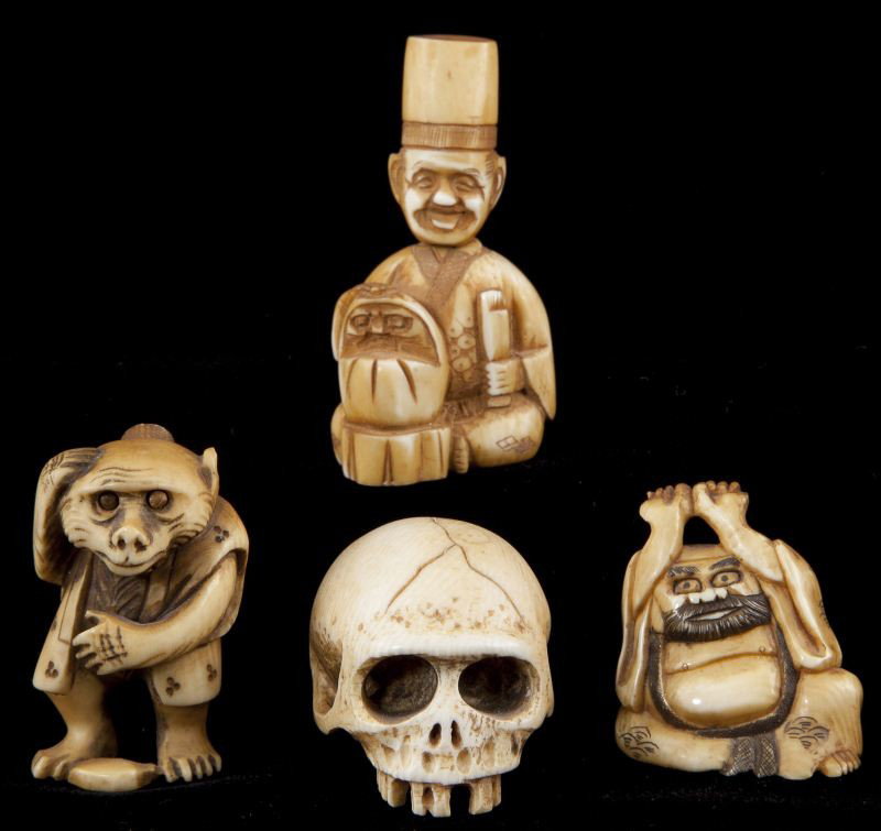 Four Ivory Netsukes: Four Ivory Netsukes the first a skull (1.25 in.); the second an older man, artist signed (1 3/8 in.); the third a monkey with bulging eyes, artist signed (chip to one ear) (1.75 in.); and the fourth a