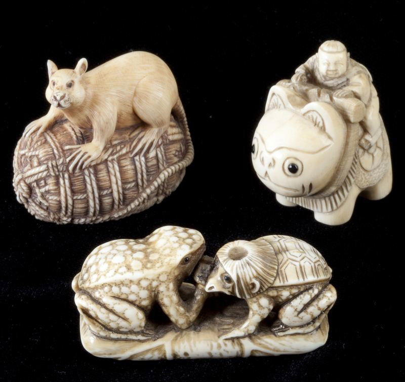 Three Japanese Ivory Animal Figural Netsuke: Three Japanese Ivory Animal Figural Netsuke all are signed and quite fanciful, with the subjects being two arm-wrestling frogs (one a turtle hybrid); a man riding a cat; and, a large alert rat straddl