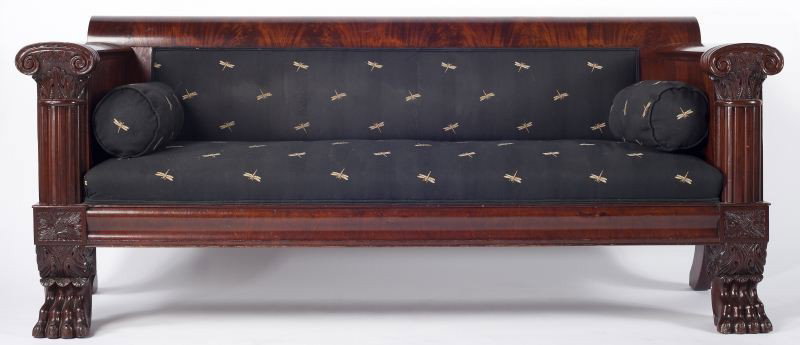 Classical Diminutive Baltimore Sofa: Classical Diminutive Baltimore Sofa circa 1820-30, mahogany and mahogany veneers, with rolled crest over upholstered back, unusual flat arm with Corinthian column arm supports, ogee seat rail under up