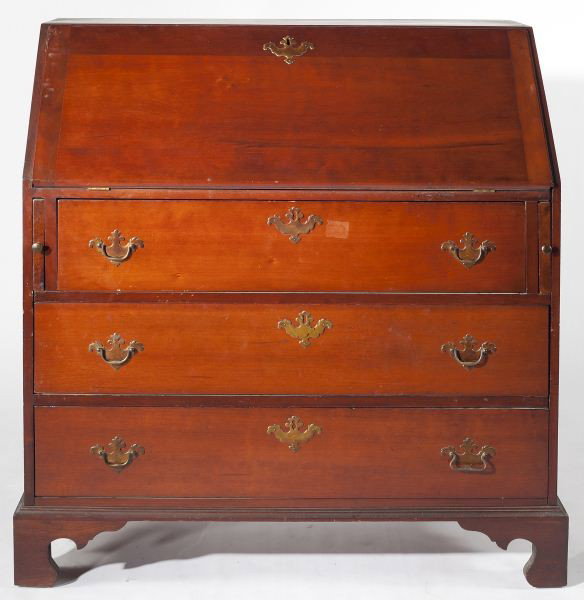American Cherry Slant Front Desk: American Cherry Slant Front Desk 19th century, with white pine secondary, desk interior with short drawer arrangement over pigeon holes, over three flush mount drawers raised on an applied shaped brac