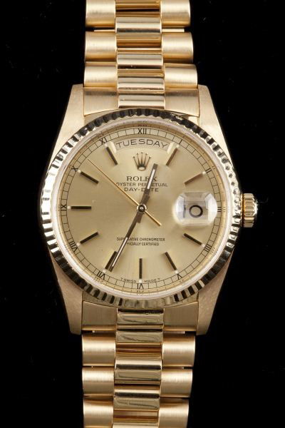 Gentleman's 18KT Rolex Oyster Perpetual Wristwatch: Gentleman's 18KT Rolex Oyster Perpetual Wristwatch with champagne dial, sapphire crystal, hour markers, sweep second hand, and day and date windows, completed by 18KT gold hidden clasp President brace