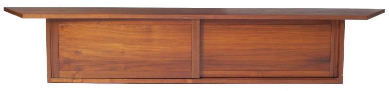 George Nakashima Hanging Wall Case: George Nakashima Hanging Wall Case (Japanese-American, 1905-1990) of solid walnut, trapezoid shape, with two sliding doors to reveal one adjustable shelf, pegged construction, wall bolts included. Uns