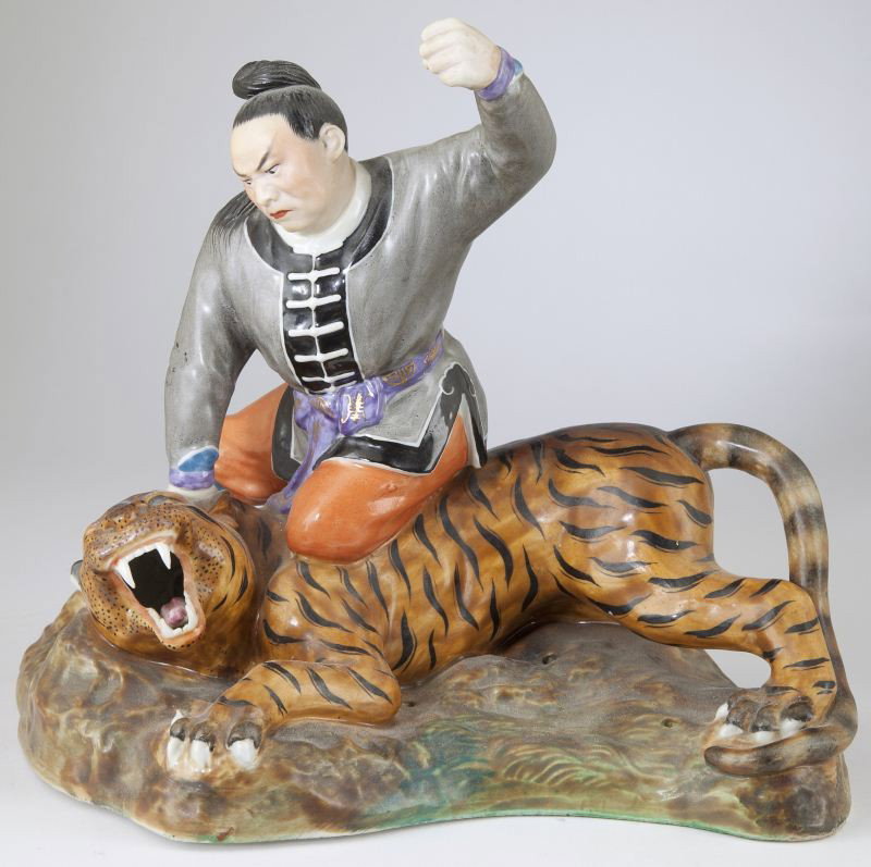 Bisque Porcelain Figural Group: Bisque Porcelain Figural Group with hand-painted overglaze enamels, a cast figural group featuring a Mongol warrior attacking a tiger, impressed mark to base, original small circular piercings to uppe