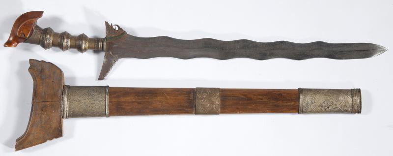 Vintage Philippines Moro Kris: Vintage Philippines Moro Kris 20th century, 26 in. LOA with 19.5 in. blade, brass grip, carved wooden pommel, wooden scabbard with brass mounts.