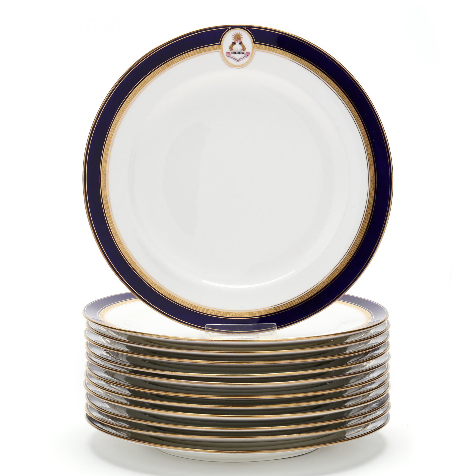Minton, A Set of Twelve Heraldic Plates: Minton, A Set of Twelve Heraldic Plates late 19th century, having a cobalt border over gilt Greek key design, broken by a heraldic oval of two ams holding a sun above the inscription Quod Honestum Uti