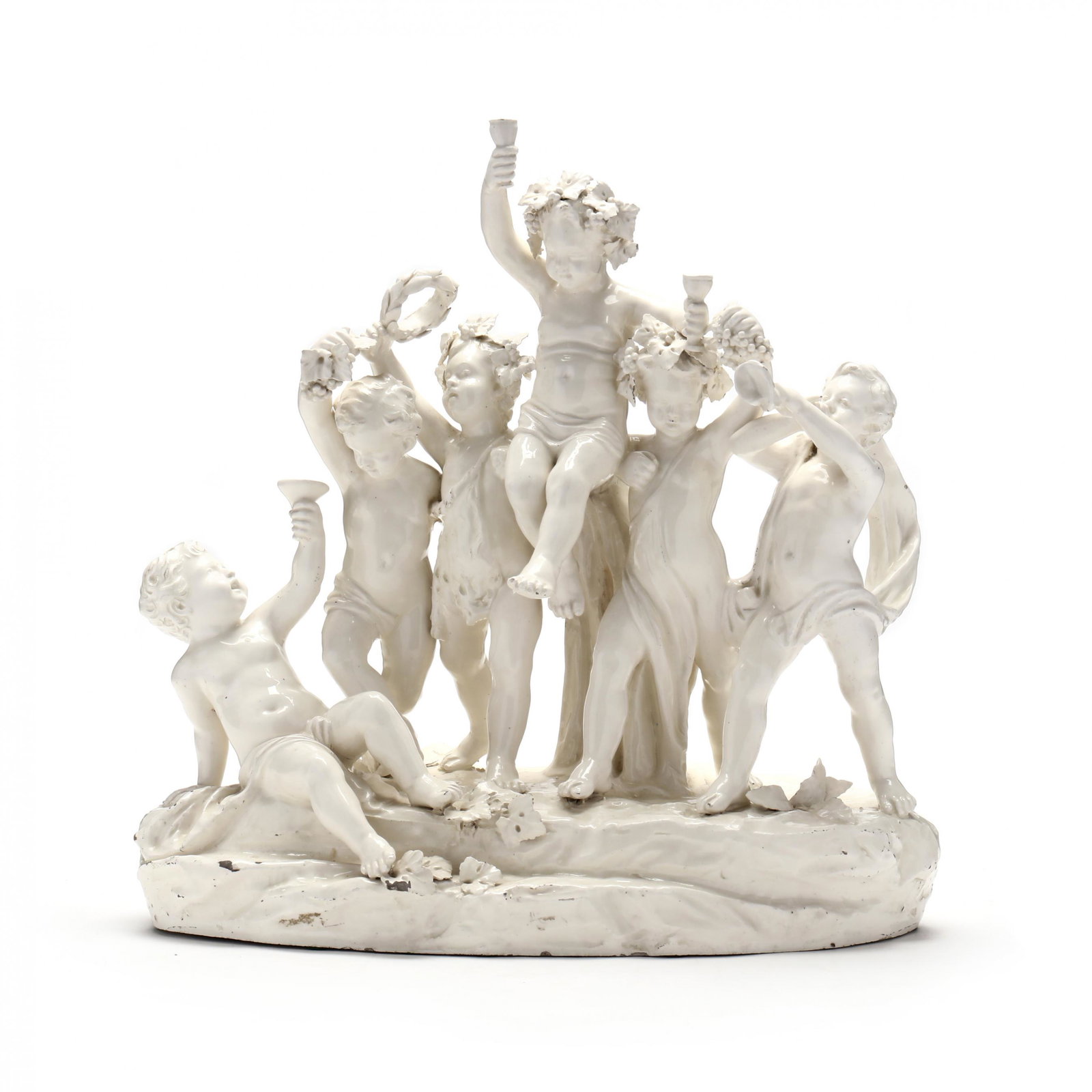 Capodimonte Style Sculpture of Bacchanalian Revelry: Capodimonte Style Sculpture of Bacchanalian Revelry 20th century, white glazed metal of six putti enjoying a wine festival, raised upon a naturalistic plinth, "Crown N" mark impressed into the glaze. 