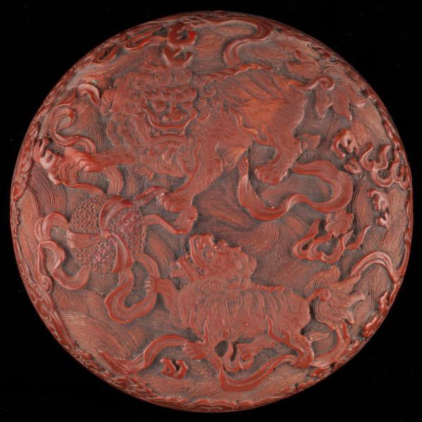 Antique Cinnabar Lacquer Box: Antique Cinnabar Lacquer Box rare double sided form, vigorously carved on one side with a mythical horned beast surrounded by swimming Koi; the opposite side carved with two combative Foo lions. Black