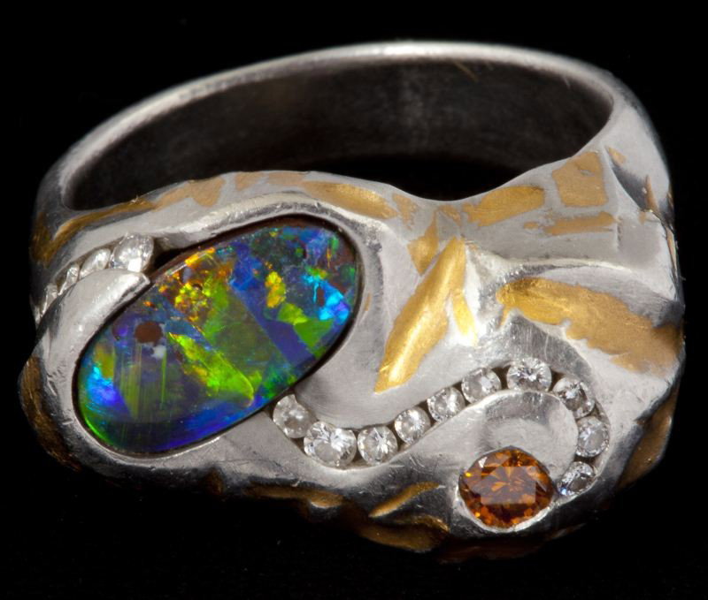 Platinum, 24KT, Diamond, and Opal Ring: Platinum, 24KT, Diamond, and Opal Ring custom made ring with 24KT yellow gold inlay consisting of (1) oval boulder opal (1.65 carat) bezel set to one side and (1) colored diamond (.14 carat) bezel on 
