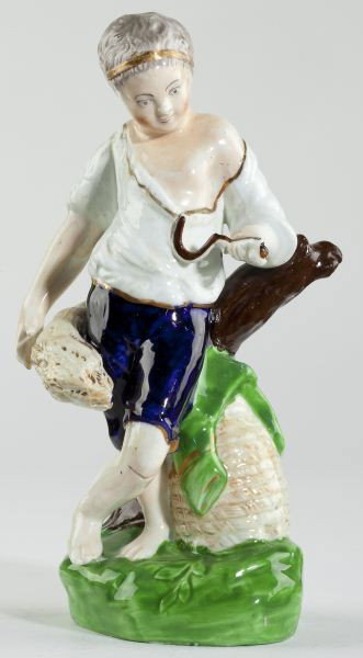 A Staffordshire Porcellaneous Figure: A Staffordshire Porcellaneous Figure attributed to John Lloyd of Shelton, circa 1830s, the figure representative of autumn, holding a wheat sheaf and sickle. 9.25 in. Property of a Charleston, South C