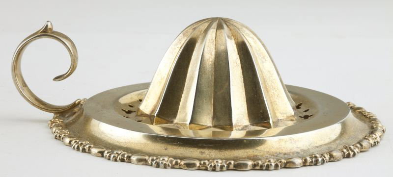 Sterling Silver Citrus Juicer, circa 1890: Sterling Silver Citrus Juicer, circa 1890 by Ferdinand Fuchs & Brothers (New York, New York), a unique silver object with ring handle and decorative rim, gilt washed, pattern number 967. 4.25 in. diam