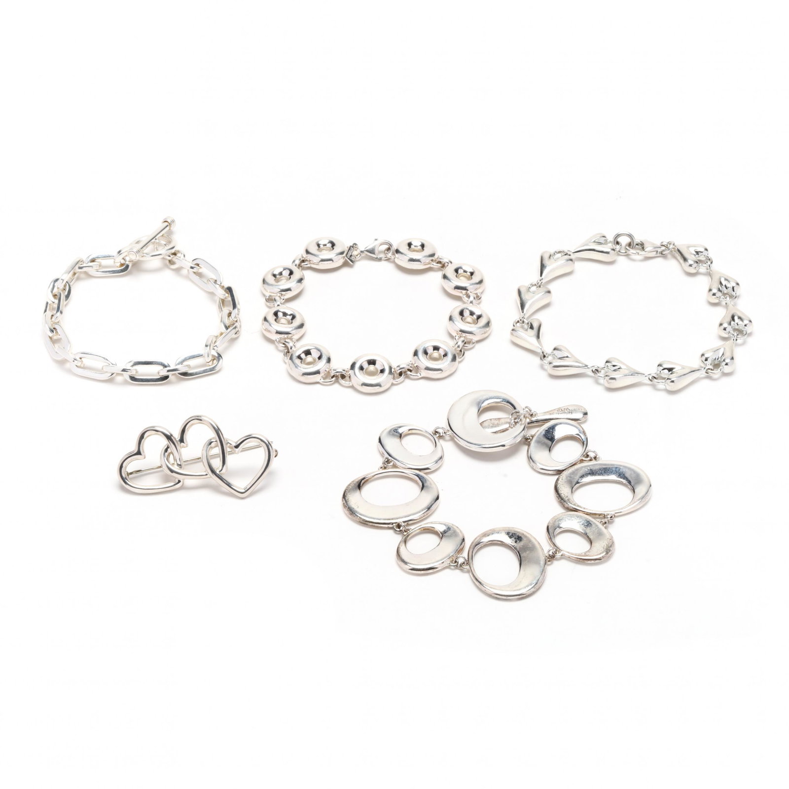 Group of Sterling Silver Jewelry Items, incl. Tiffany & Co. and Robert Lee Morris: Group of Sterling Silver Jewelry Items, incl. Tiffany & Co. and Robert Lee Morristo include: a Tiffany & Co. heart brooch with three open hearts, completed with a single locking pin stem, stamped 925