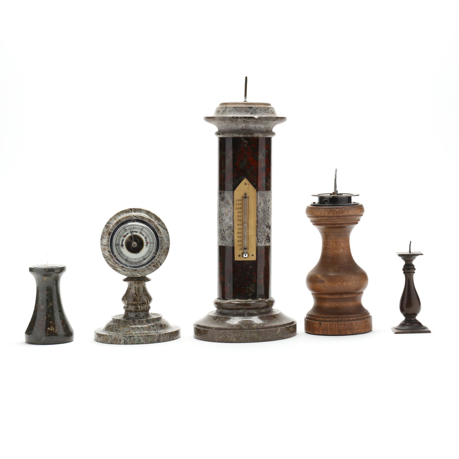 A Collection of Four English Sundials and a Barometer: A Collection of Four English Sundials and a Barometerlate 19th to mid 20th century, including an aneroid barometer with round dial within a polished gray hardstone, stand (7 in.); the tallest of colum