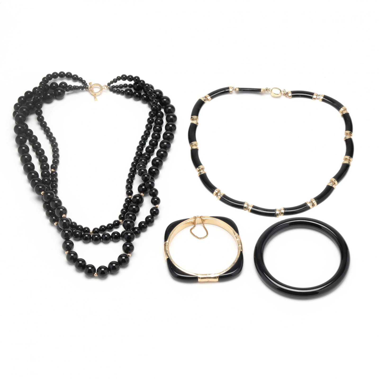 Group of Black Onyx Jewelry Items: Group of Black Onyx Jewelry Items to include: a triple strand of graduated black onyx beads (4mm - 10.3mm), completed with a gold-tone toggle clasp (18 in.); a necklace comprised of curved black onyx 