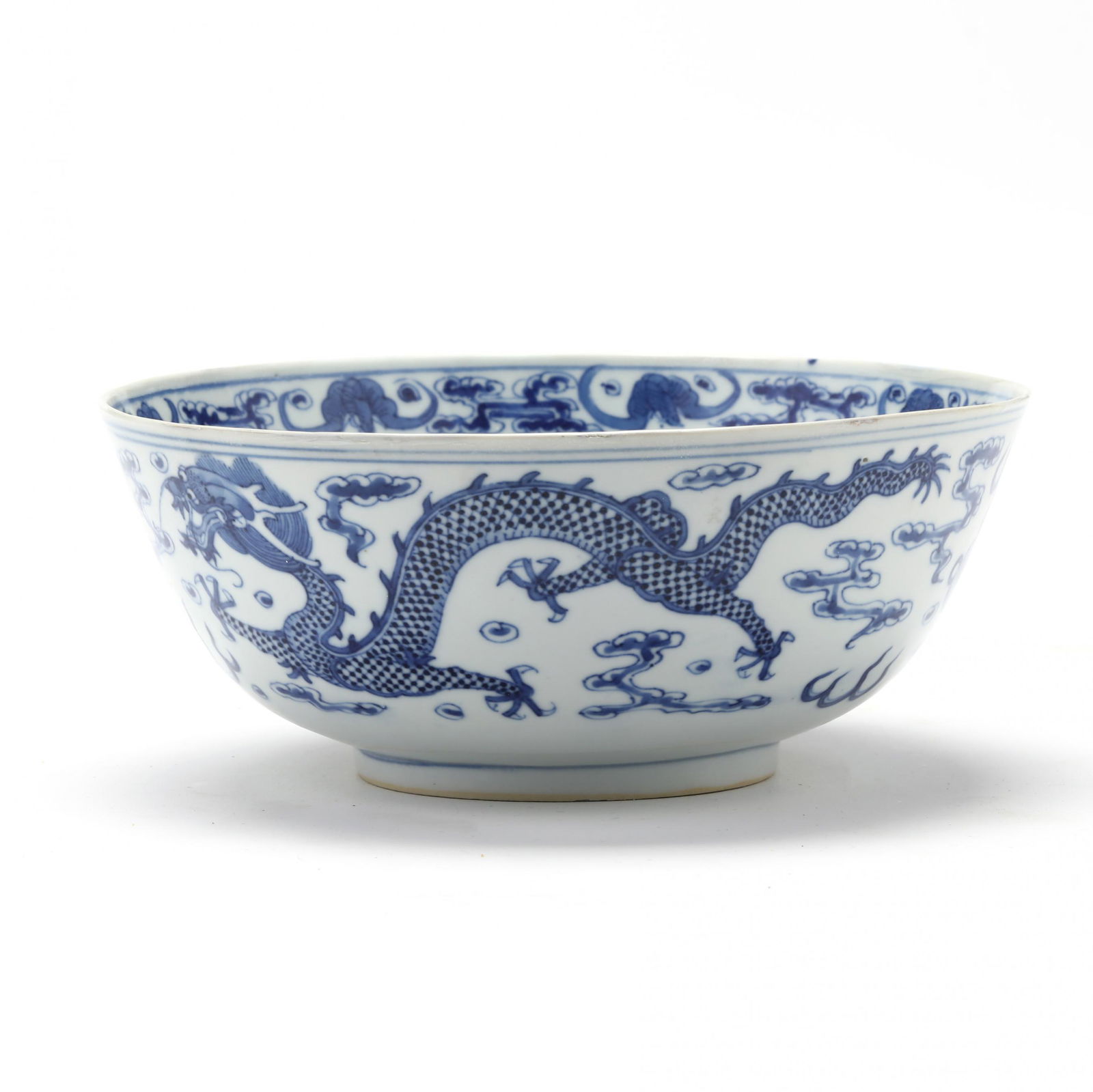 A Chinese Porcelain Blue and White Dragon Bowl: A Chinese Porcelain Blue and White Dragon Bowl19th century, porcelain hand painted in underglaze blue with a four claw frontal facing dragon surrounded by fire bands and clouds to the interior well, i
