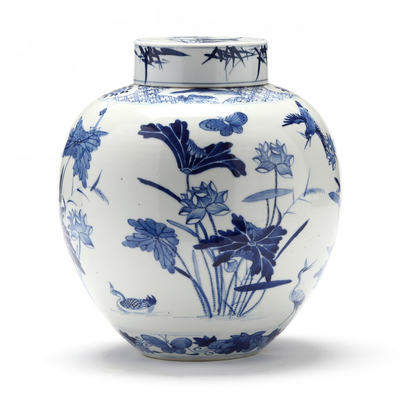 A Chinese Porcelain Blue and White Ginger Jar with Lotus: A Chinese Porcelain Blue and White Ginger Jar with Lotus19th or 20th century, very finely potted ginger jar with cover, porcelain hand painted in underglaze blue with lotus plants, birds, and flowers,