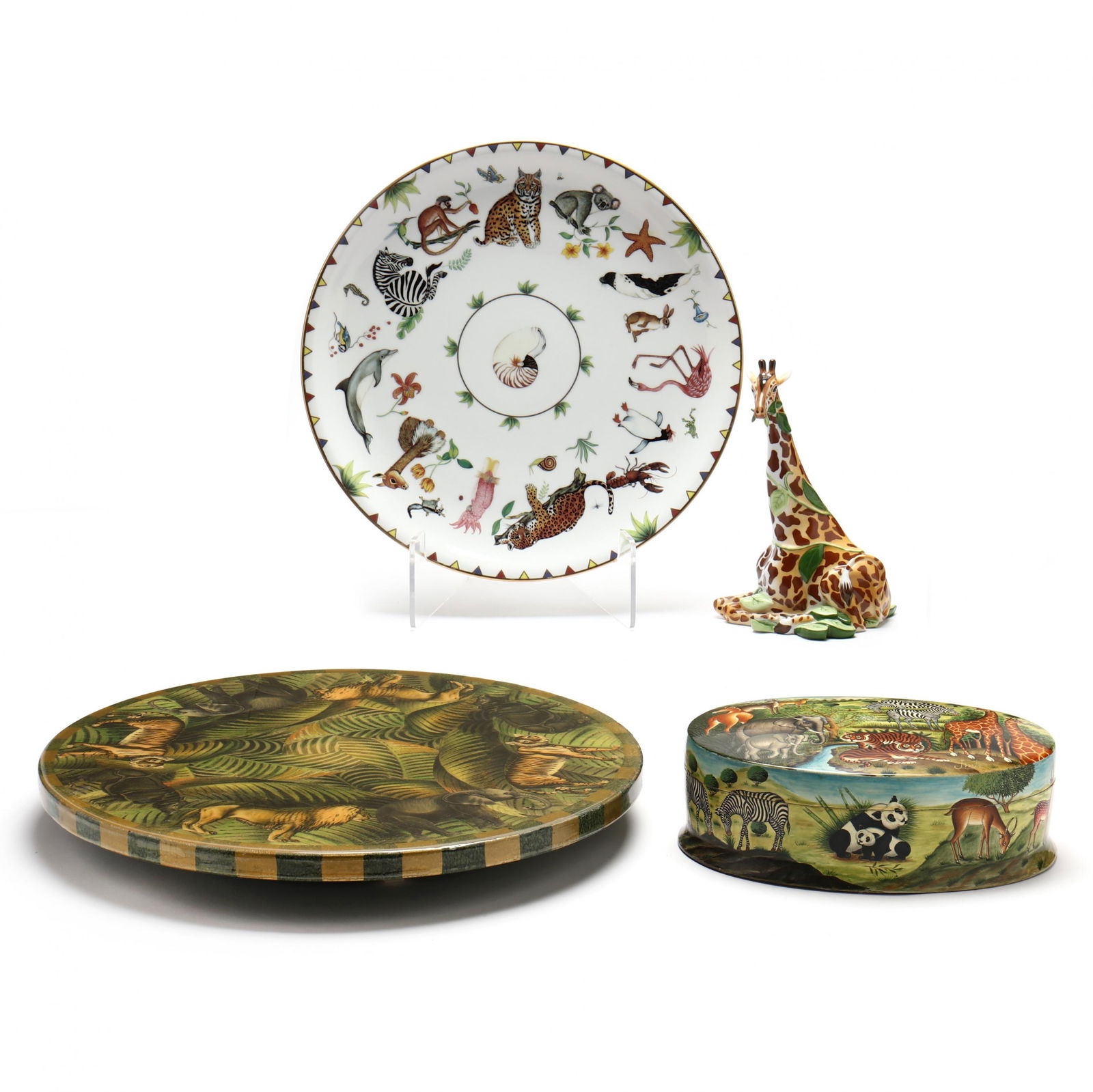 Four Decorative African Themed Table Accessories, including Lynn Chase: Four Decorative African Themed Table Accessories, including Lynn Chasesecond half 20th century, including a Lynn Chase porcelain giraffe; Lynn Chase Harmony porcelain charger; hand-painted oval box by