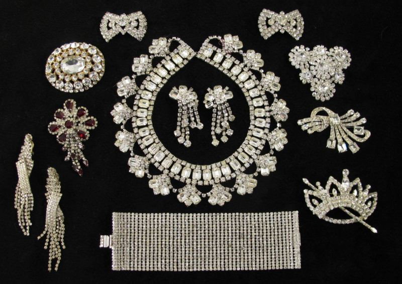 A Grouping of Rhinestone Costume Jewelry: A Grouping of Rhinestone Costume Jewelry including a wide flexible cuff bracelet signed Trigere (7 in.); floral spray brooch signed Joseph Wiesner NY (3 in.); brooch signed Hattie Carnegie (2.5 in.); 