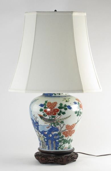 Antique Chinese Ginger Jar Table Lamp: Antique Chinese Ginger Jar Table Lampwhite porcelain table lamp, ginger jar form with over painted decoration of birds on a rocky landscape in reds, blue and greens, mounted to a well carved hardwood