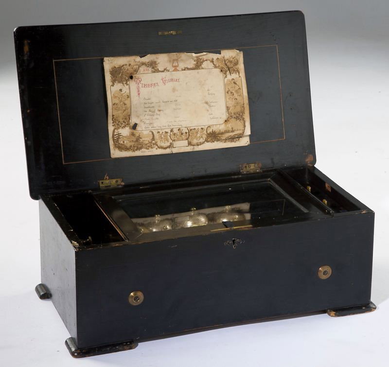 French Single Comb Cylinder Music Box: French Single Comb Cylinder Music Box circa 1900, the mechanism under the glass lid also includes three bells and a tune selector for eight pieces of music; the case is painted black, its lid inlaid w