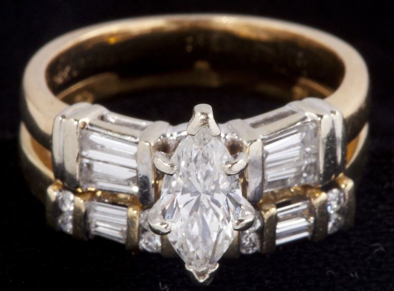 Gold and Diamond Bridal Set: Gold and Diamond Bridal Setset consisting of one marquise cut diamond (approximately .55 carat) prong set and flanked on each side with (4) baguette and (4) full cut round diamonds bar set (approximat