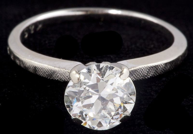Diamond Solitaire: Diamond Solitaire set with one round brilliant solitaire (approximately 1.26 carat, I1 clarity, K color) in four prong white gold mounting stamped 14KT. Ring size 5 Approximately 1.4 dwt. Professional
