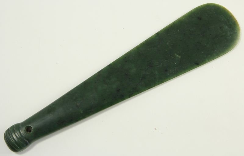 Maori Mere Pounamu (Greenstone Maori Hand Club): Maori Mere Pounamu (Greenstone Maori Hand Club) tapering form with rounded flat end and carved details to handle with pierced hole to handle; also known as a patu pounamu. 15.25 x 3 3/8 in.