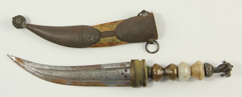 Persian Dagger, circa 1800: Persian Dagger, circa 1800 curved blade with etched scroll motif and three star stamps, carved stone guard with double masks, four silt onyx beads with inlaid gold geometric designs and capped by a si
