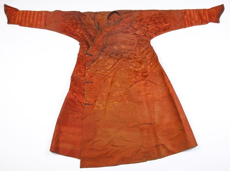 Chinese Ceremonial Robe: Chinese Ceremonial Robe 19th century or earlier, depicting the Imperial five-clawed dragon amidst clouds and cranes woven on brocaded rust silk with (5) gold tone rosette buttons, sleeve caps lined in