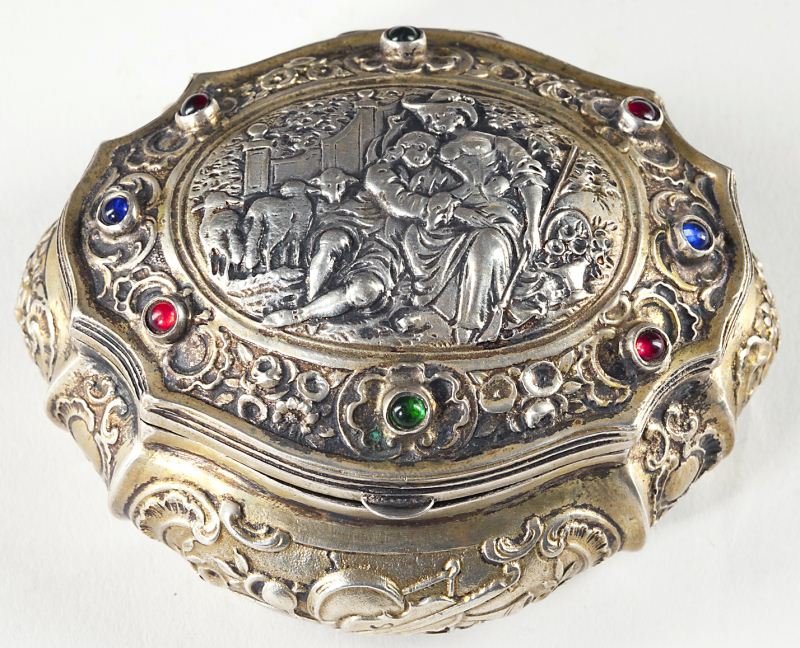 Continental Silver Dresser Box: Continental Silver Dresser Box 18th century, lozenge form with finely detailed figural scene of two lovers amidst sheep, surrounded by inset stones likely to be rubies, sapphires and emeralds, the lob