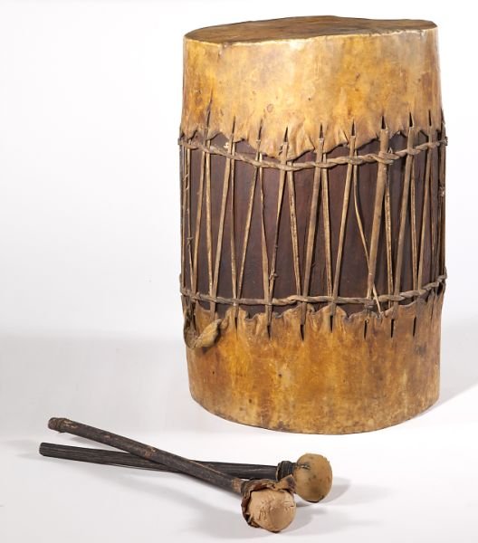 African Wood Drum: African Wood Drum late 19th century, skin heads, with drum sticks. 27 in. high x 18 in. diameter