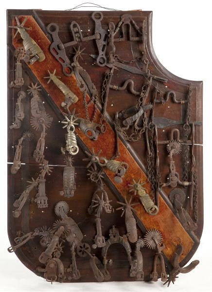 Shaped Panel of Antique Spanish Steel Bits & Spurs: Shaped Panel of Antique Spanish Steel Bits & Spurs various ages, 18th and 19th centuries, wrought iron, brass, (32) spurs and (7) bits, mounted on a mahogany panel. Purchased in Spain by the Penns in 