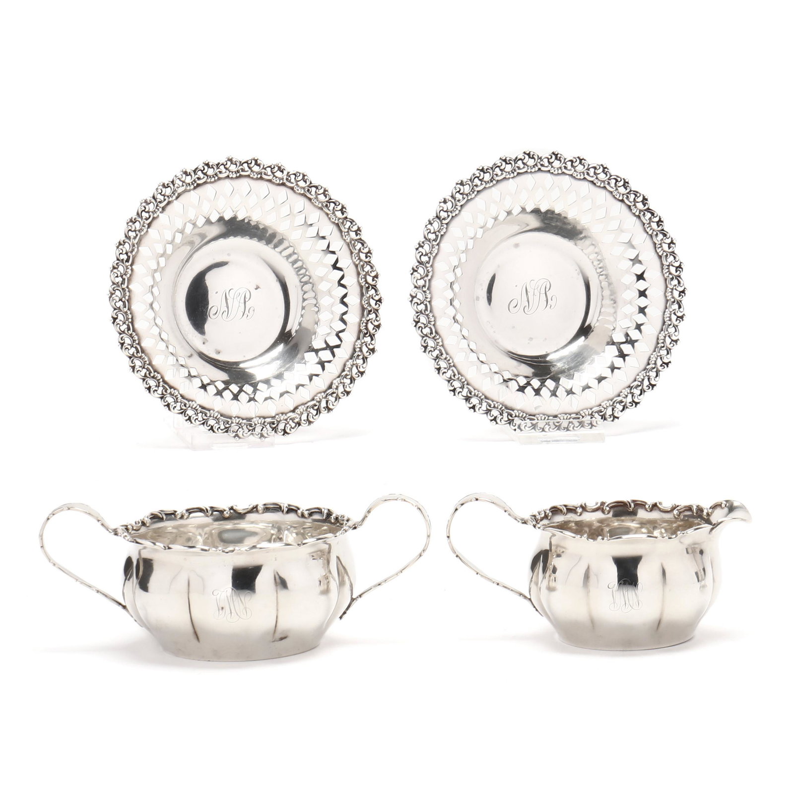 Four Sterling Silver Table Accessories by Towle: Four Sterling Silver Table Accessories by Towlecirca 1900; including a sugar and creamer set with scroll motif to rim, model number 258, each with period "VMN" monogram (creamer 7 in. across); and a p