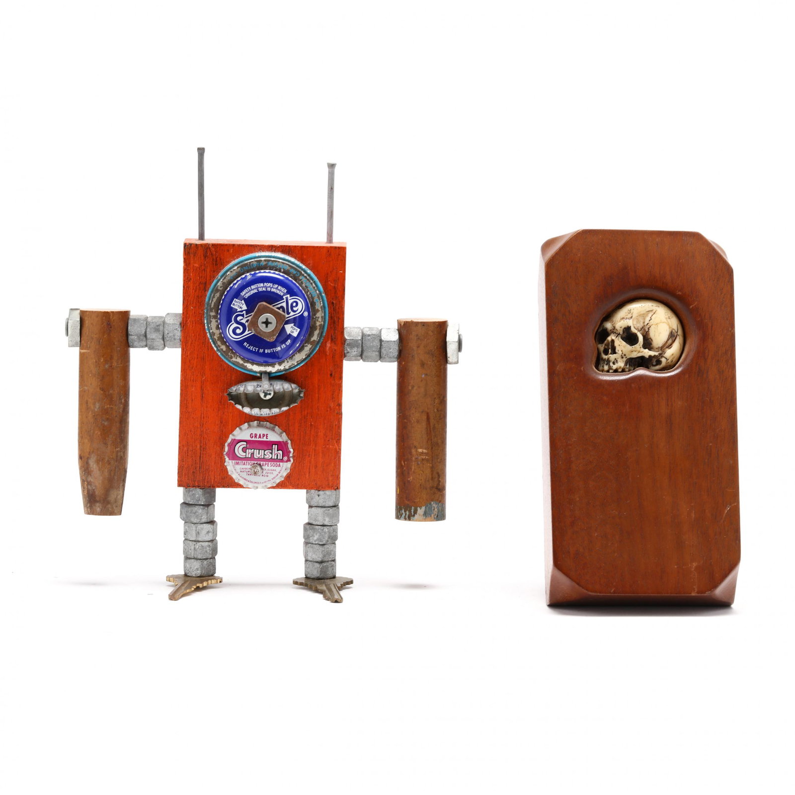 Two Signed Pieces of Folk Art: Two Signed Pieces of Folk Artincluding a carved bone skull set in mahogany signed JR Baxter and dated 3/9/76 (7 x 3.5 in.); and a Mark May assembled standing figure, signed and dated 2007, further tit